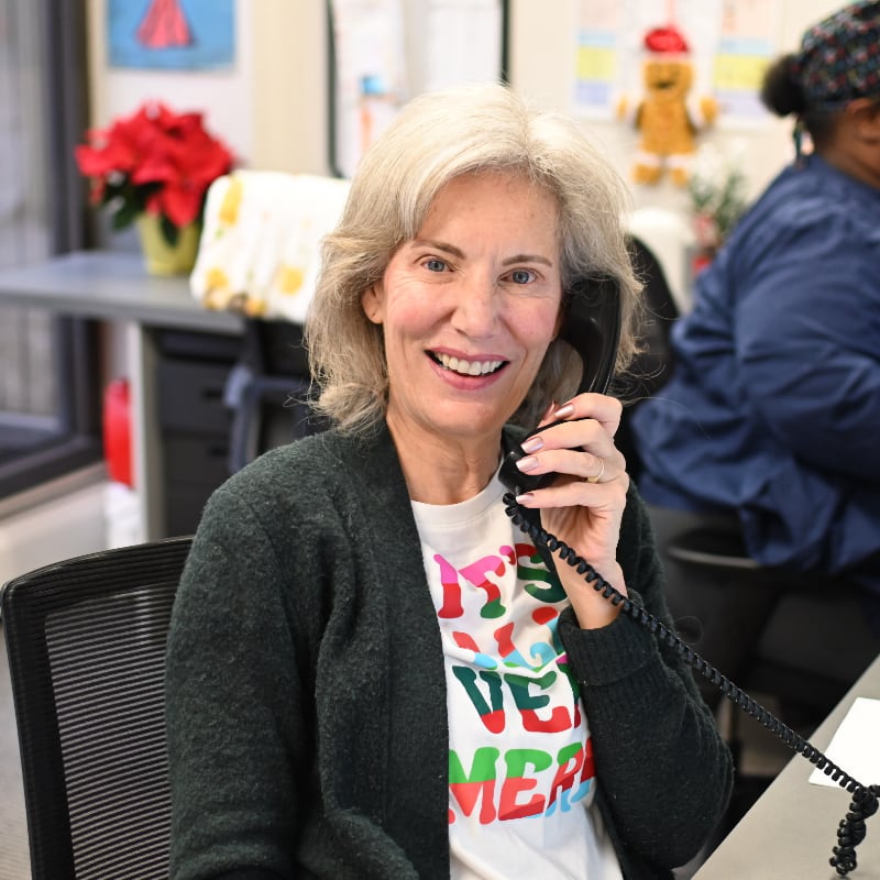 A receptionist answers the phone at the front desk