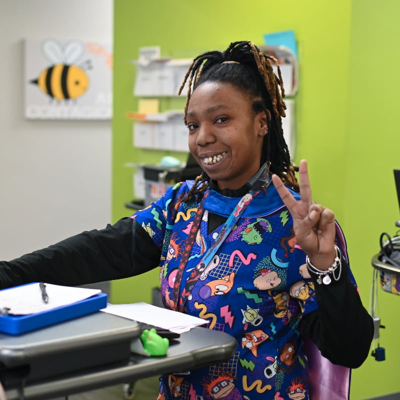 Smiling woman wearing scrubs
