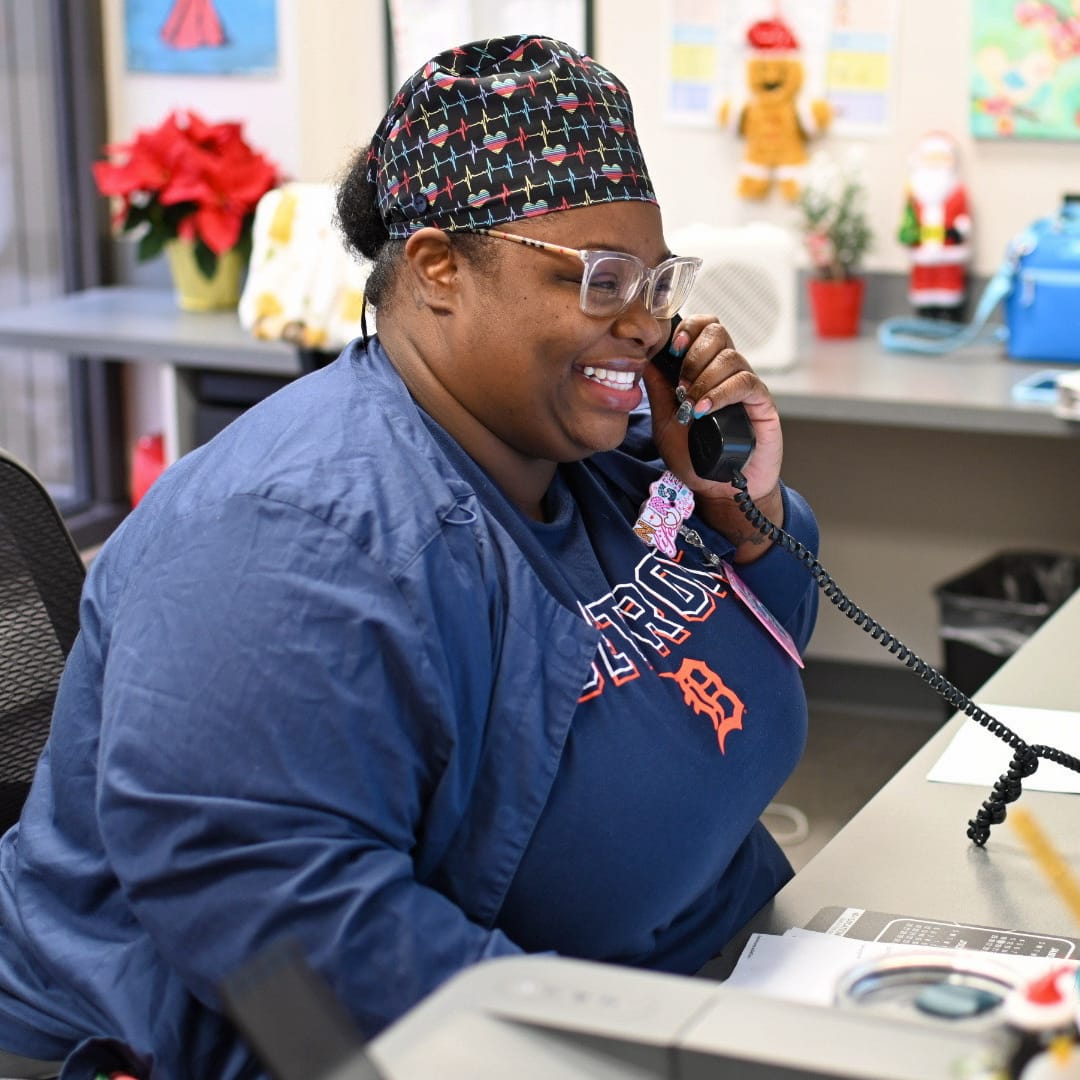 A receptionist answers the phone at the front desk
