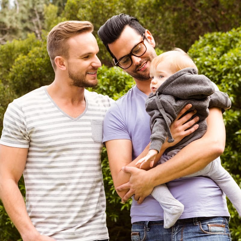 New Patients Two fathers hold their toddler